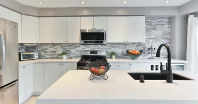 Ansicht einer modernen weißen Küche mit Kochinsel und Küchengeräten