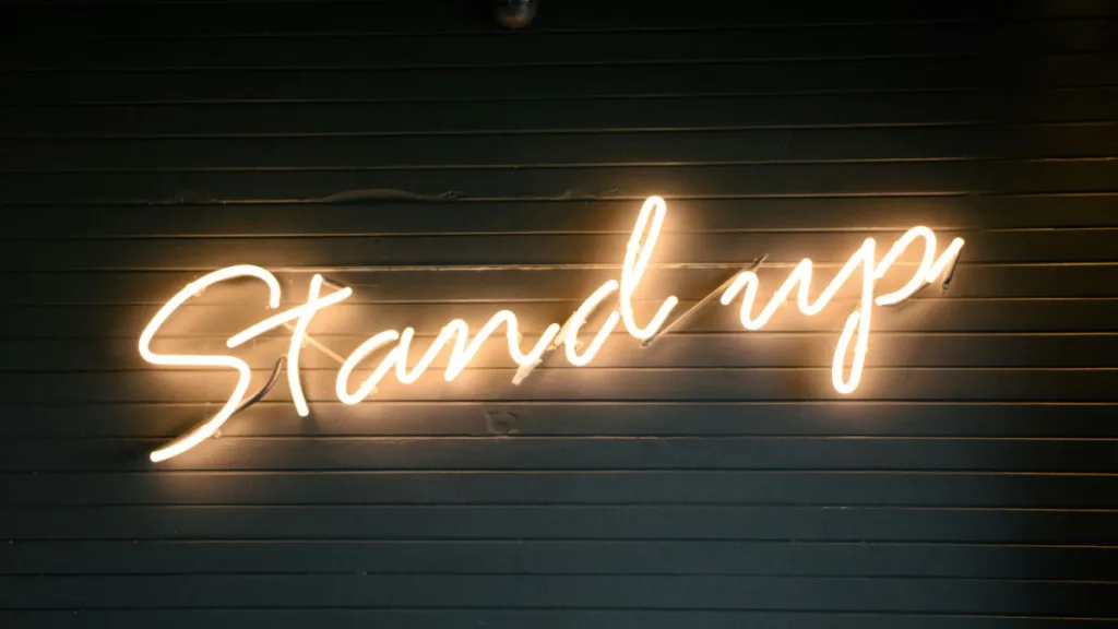 leuchtende Neonlichter mit der Aufschrift "Stand up"