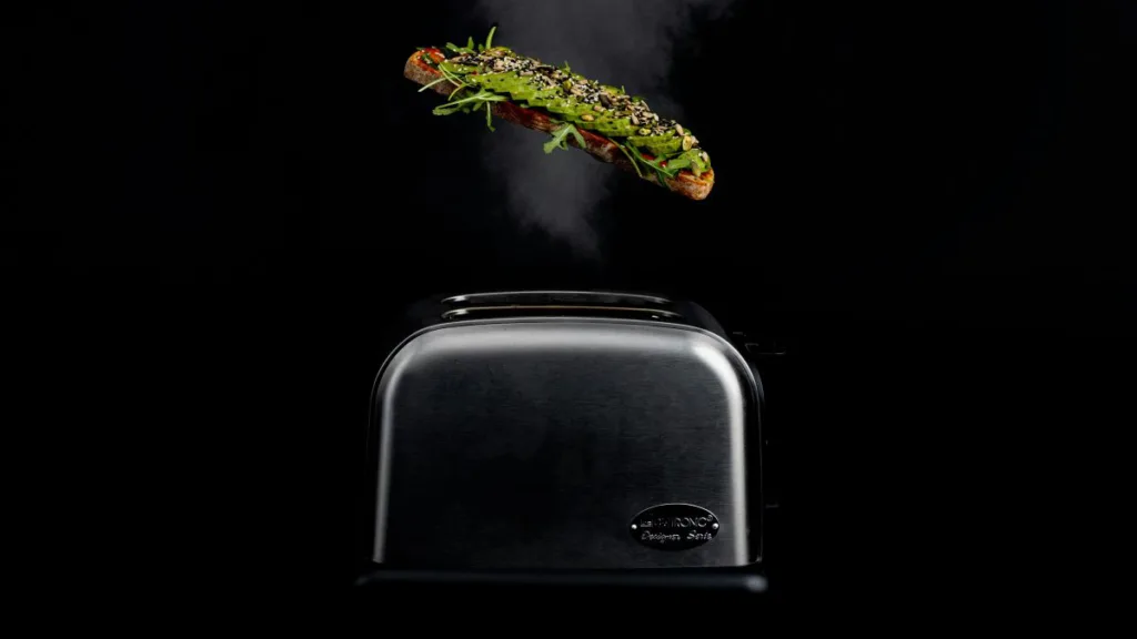 eine getoastete Scheibe Brot über einem Toaster, schon fertig belegt