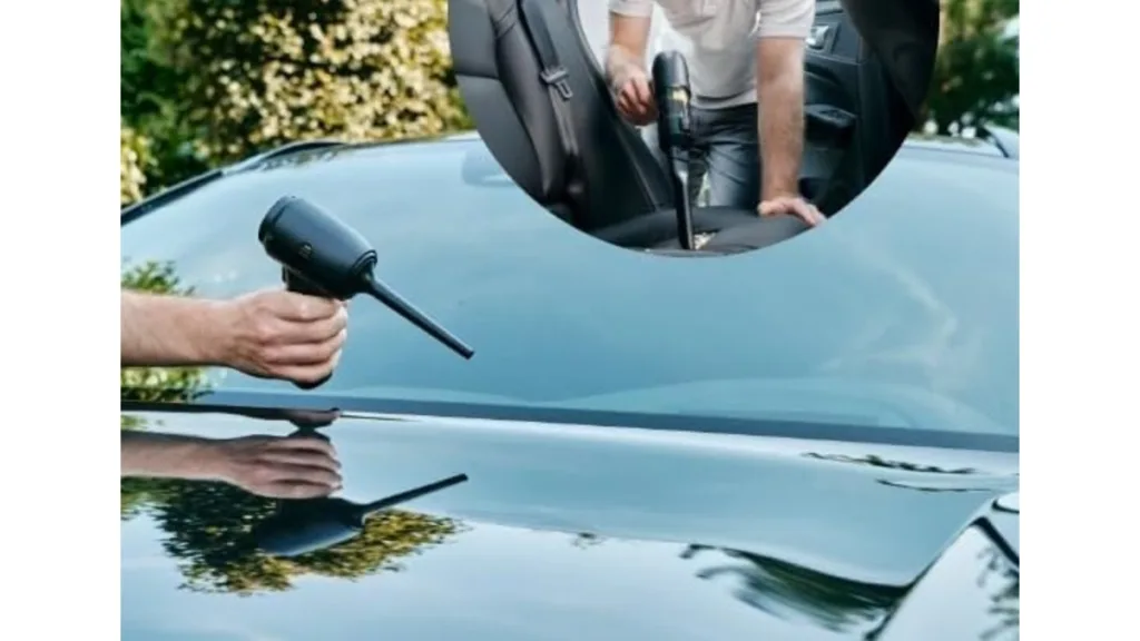 ein schwarzes Auto wird mit einem Handstaubsauger außen und innen gereinigt